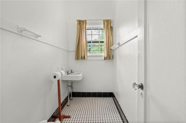 Half Bathroom featuring tile patterned floors | Image 13