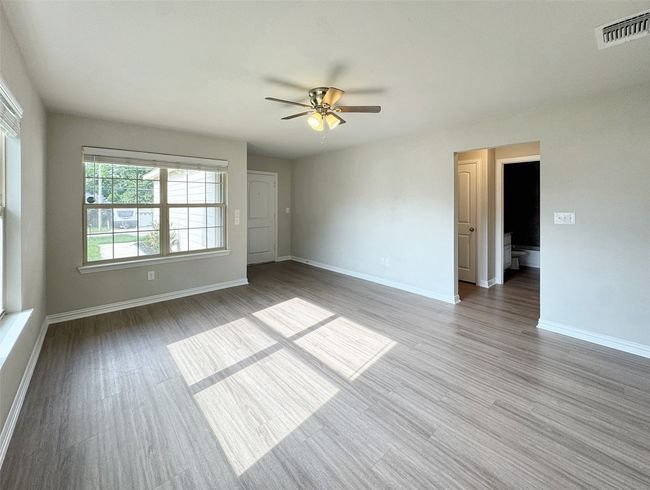 Empty room with ceiling fan and wood finished floors | Image 7