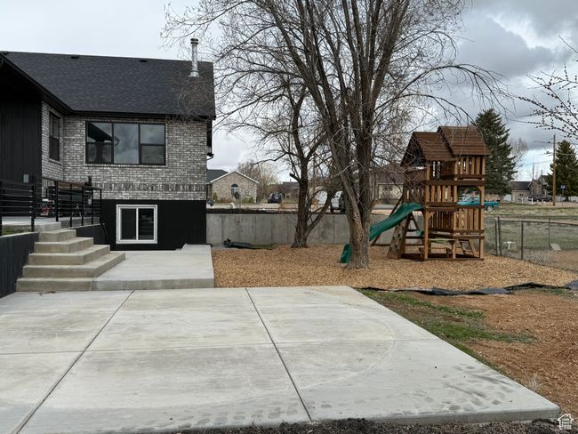 View of yard with a fenced backyard, playground community, and a patio area | Image 25
