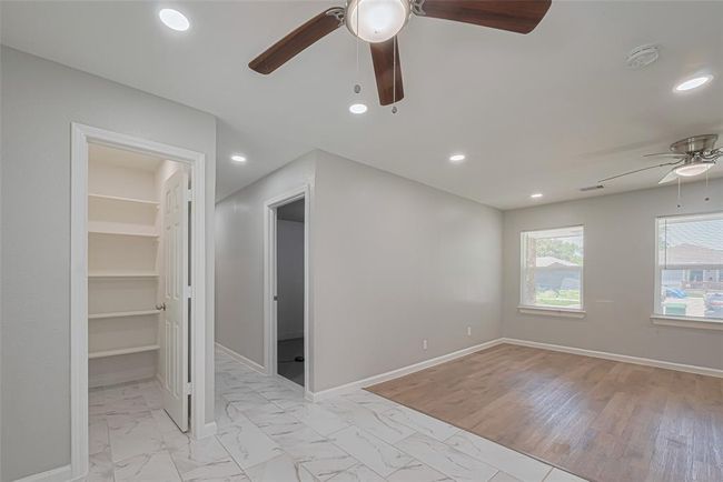 A generous pantry located next to the dining area features built-in shelving to keep everything organized and accessible. | Image 14