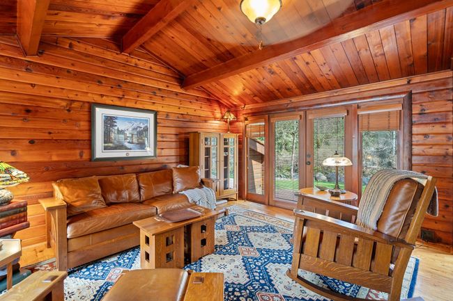 Living area featuring wood finished floors, wooden ceiling, wood walls, and french doors | Image 7