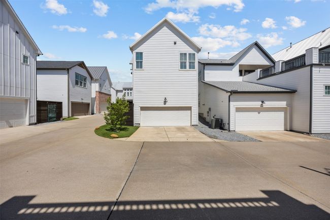View of front of house with a residential view, concrete driveway, and a garage | Image 33