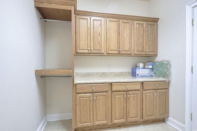 Kitchen featuring light countertops and light tile patterned floors | Image 21