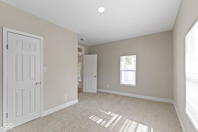unfurnished bedroom with carpet floors, multiple windows, baseboards, and recessed lighting | Image 29
