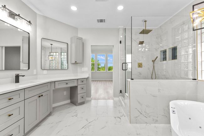 The all new primary bathroom has beautiful floors, dual vanity with lots of storage space. | Image 5