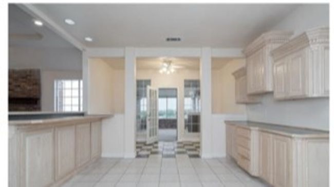 Kitchen featuring light brown cabinetry, ceiling fan, and light tile patterned floors | Image 11