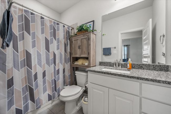 Full bath featuring vanity, tile patterned flooring, and a shower. | Image 17