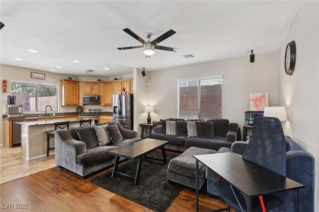 Living room with ceiling fan, light wood-style floors, and recessed lighting | Image 20