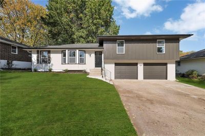 Tri-level home with a front lawn and a garage | Image 1