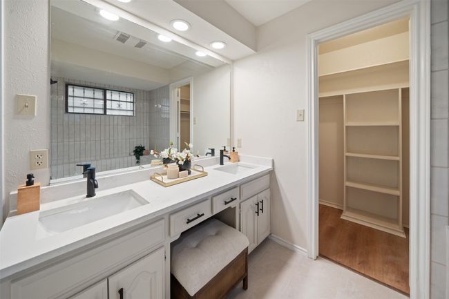 Bathroom with double vanity, a spacious closet, a sink, and recessed lighting | Image 14