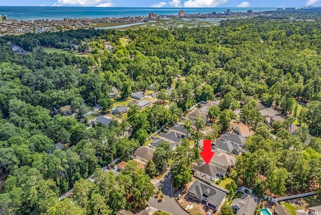 Aerial view of residential area with a nearby body of water and a forest | Image 29