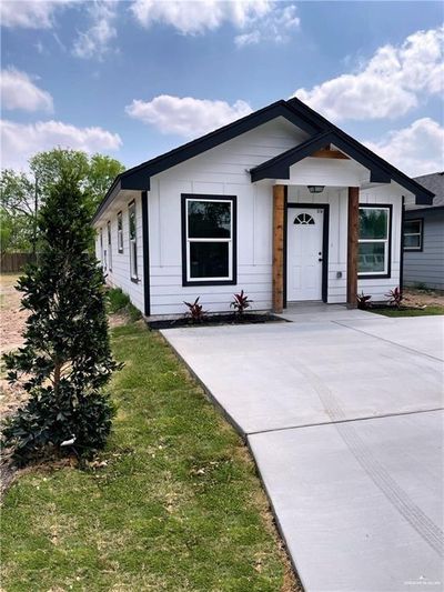 Single story home featuring a porch | Image 1