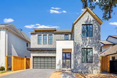 Contemporary garage door with privacy glass. Pavered driveway. Double door entry. Brick and artisan board exterior. Construction picture taken October 17, 2024. | Image 2