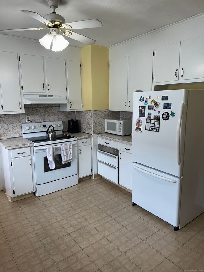 All white appliances, including newer refrigerator and oven range. The floor will be getting replaced shortly and refreshed cabinet hardware | Image 8