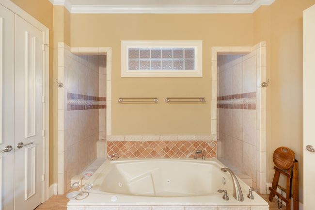 Bathroom with a whirlpool tub and crown molding | Image 19