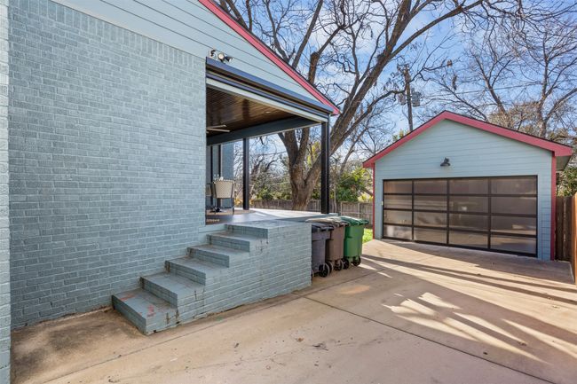 Gated driveway leading to garage. | Image 31