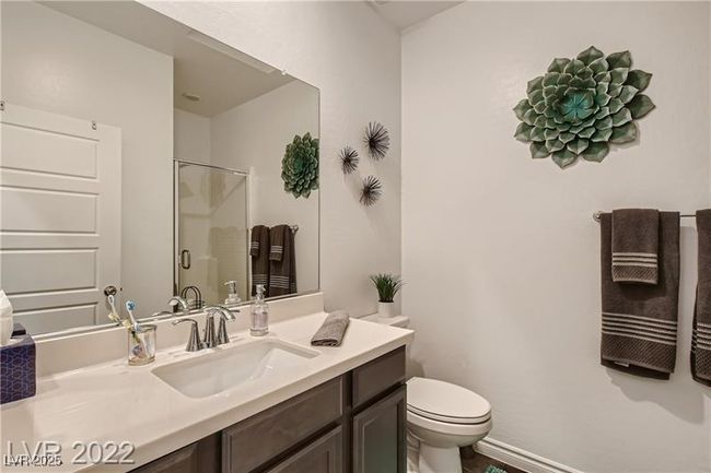 Full bath with baseboards, a shower stall, toilet, and vanity | Image 14