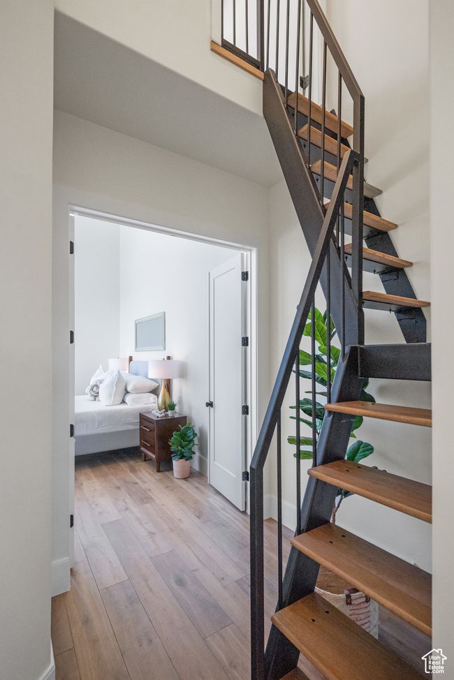 Stairway featuring hardwood / wood-style floors and baseboards. This takes you up to the loft | Image 47