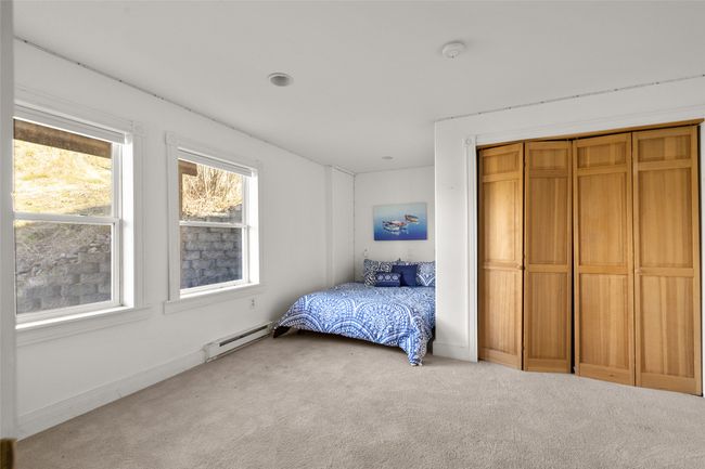 Bedroom featuring a closet, and light colored carpet | Image 26
