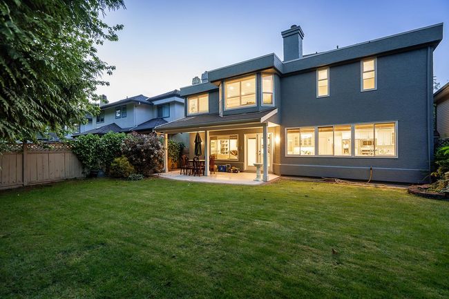 Back of house featuring a patio, a chimney, and stucco siding | Image 28