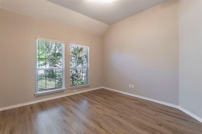 Spare room featuring wood finished floors, a healthy amount of sunlight, and baseboards | Image 21