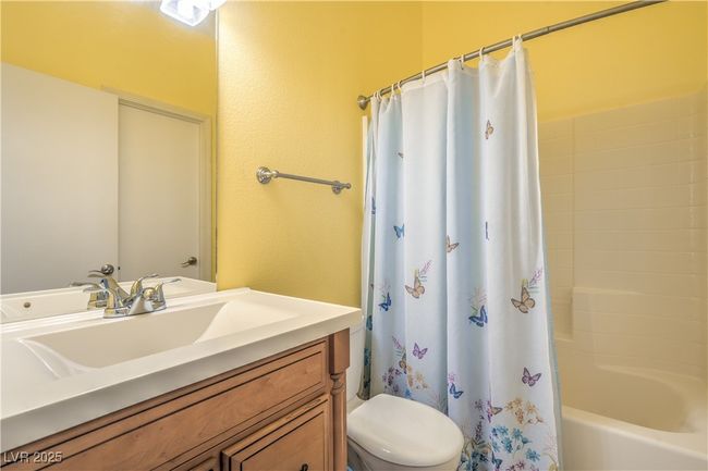 Bathroom with vanity, toilet, and shower / tub combo with curtain | Image 23