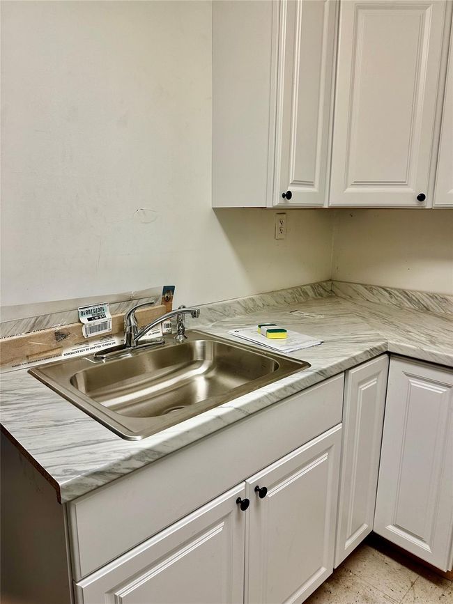 Kitchen featuring white cabinetry and sink | Image 22