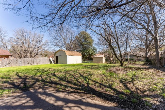 View of yard with a storage shed, an outdoor structure, and fence | Image 16