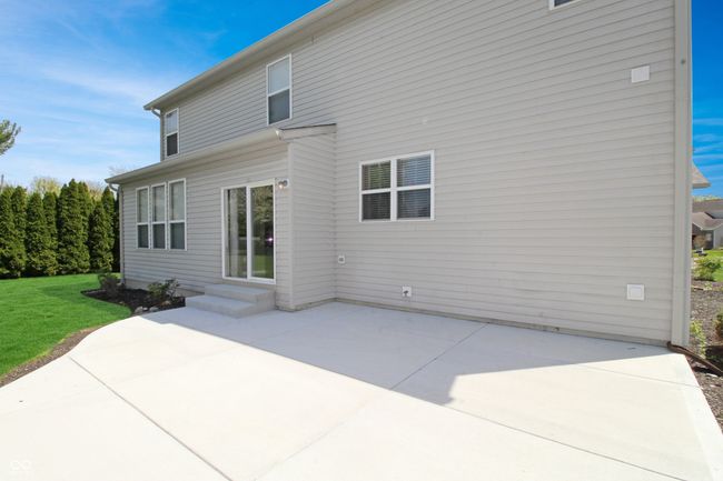 This oversized concrete patio offers a blank canvas for your outdoor design ideas - plenty of room for furniture, planters, and creating your ideal backyard oasis. | Image 19