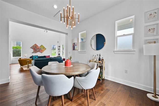 Dining area with dark wood-style floors and a chandelier | Image 6