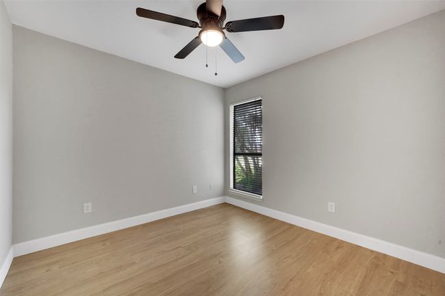 Spare room featuring light wood-style floors and a ceiling fan | Image 21