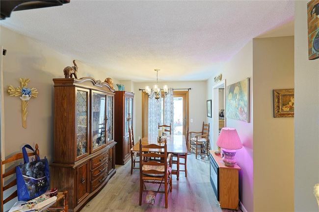 Dining area with sliding doors to deck a chandelier, hardwood / wood-style flooring | Image 6