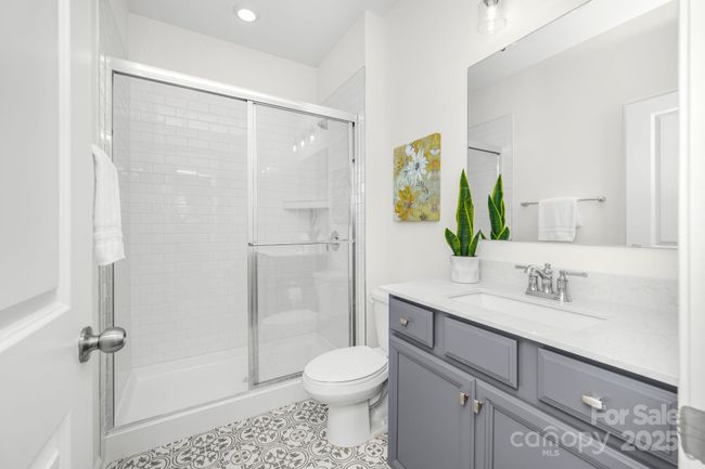 Full bath down with ceramic tile floors and shower | Image 6