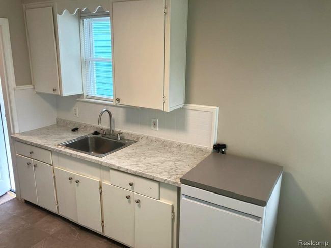 Eat-in kitchen, freshly painted, new vinyl flooring. | Image 8