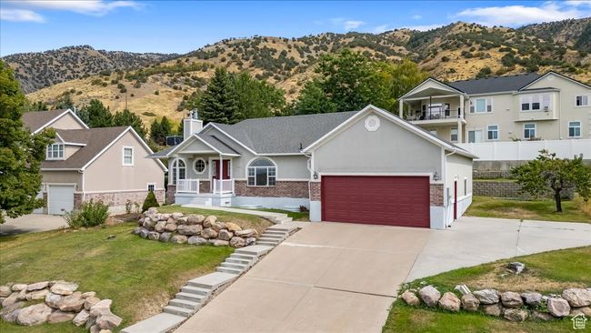 View of front facade with a mountain view, a front yard, and a porch | Image 46