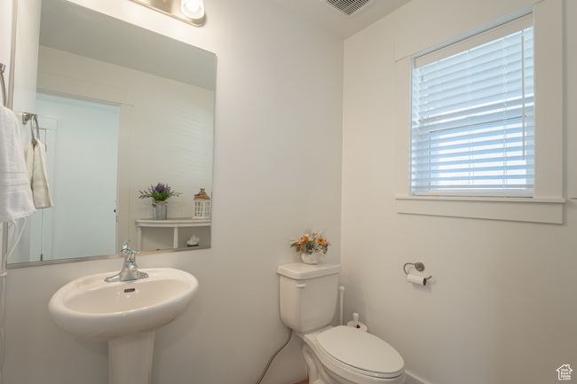 Bathroom with toilet and visible vents | Image 8