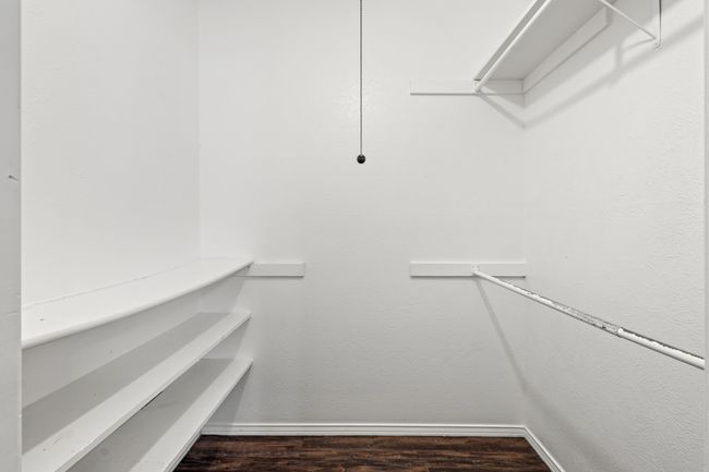 Walk in closet featuring wood finished floors | Image 22