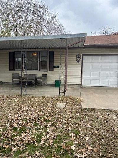 View of front of home featuring a garage and a porch | Image 1