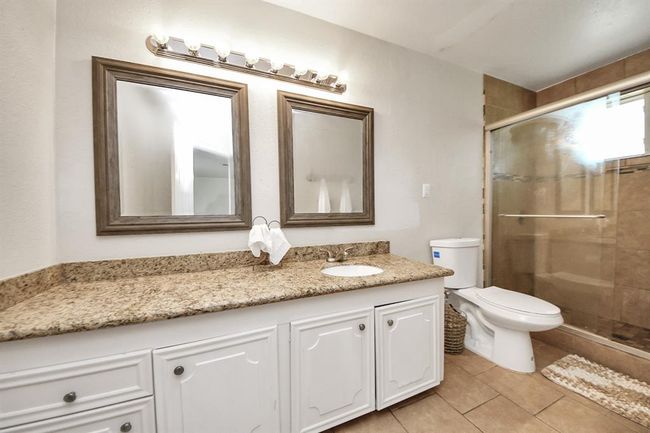 Features a large walk-in shower and generous countertop space—comfort and convenience in a stylish setting. | Image 23