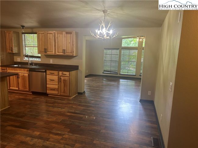 Kitchen and dining area lookin into Den. Look at those vaulted ceilings. | Image 6