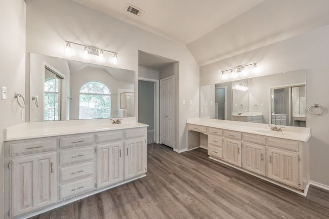 Double vanities in the primary bathroom offering lots of cabinet space. There is a linen closet as well for additional storage. | Image 25