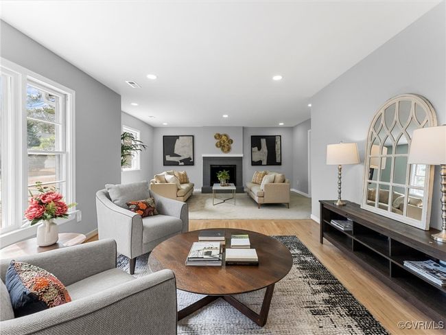 Living room featuring light wood-type flooring, a fireplace, visible vents, and recessed lighting | Image 6