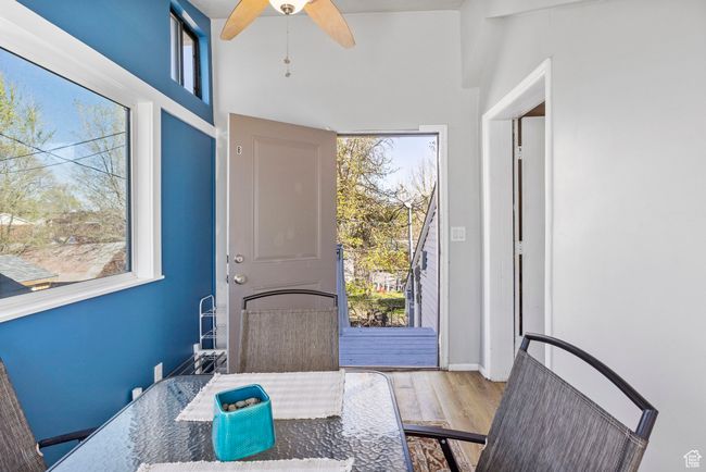Dining room with ceiling fan, plenty of natural light, wood finished floors, and baseboards | Image 8