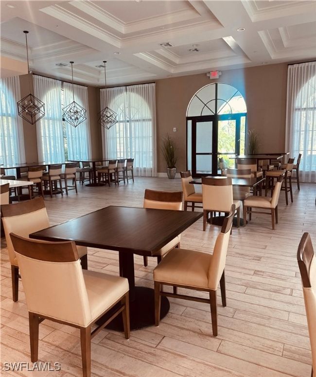 Dining room with coffered ceiling, ornamental molding, beamed ceiling, and light hardwood / wood-style flooring | Image 42