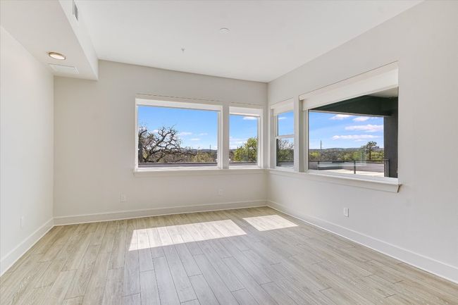 Spare room with plenty of natural light, wood finished floors, and baseboards | Image 9