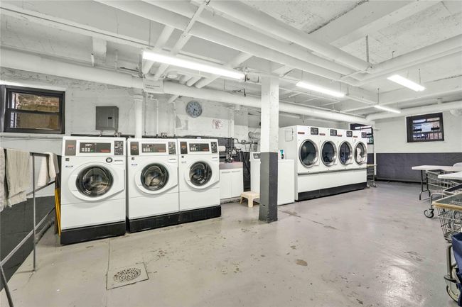 Below grade area featuring washing machine and clothes dryer and electric panel | Image 25