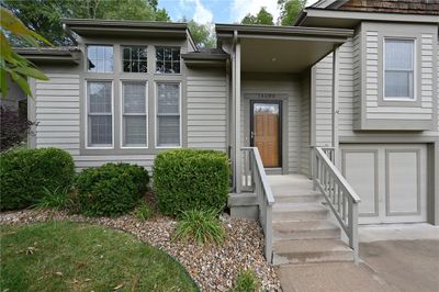 View of front of home with a garage and a front lawn | Image 2