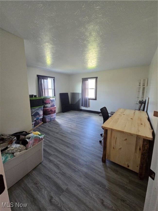 Office space with dark wood-style flooring and a textured ceiling | Image 22