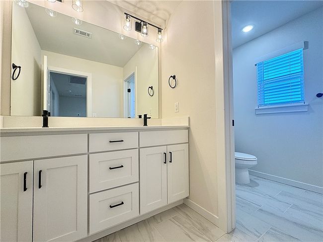 The secondary bathroom is a sleek and modern space, featuring elegant finishes and fixtures, providing a comfortable and functional design for everyday use. | Image 19