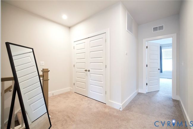 Hallway featuring light colored carpet and baseboards | Image 15